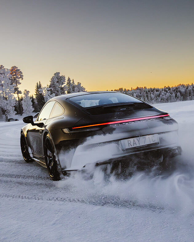 Porsche 911 w poślizgu na tle zachodzącego słońca